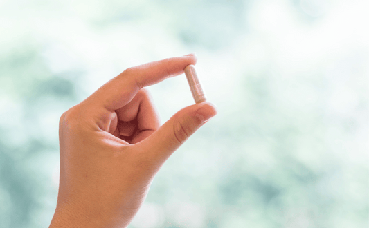 Holding a whole food supplement pill